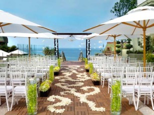 aisle with flower petals leading to the beach