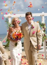 beach wedding recessional with flower petals thrown